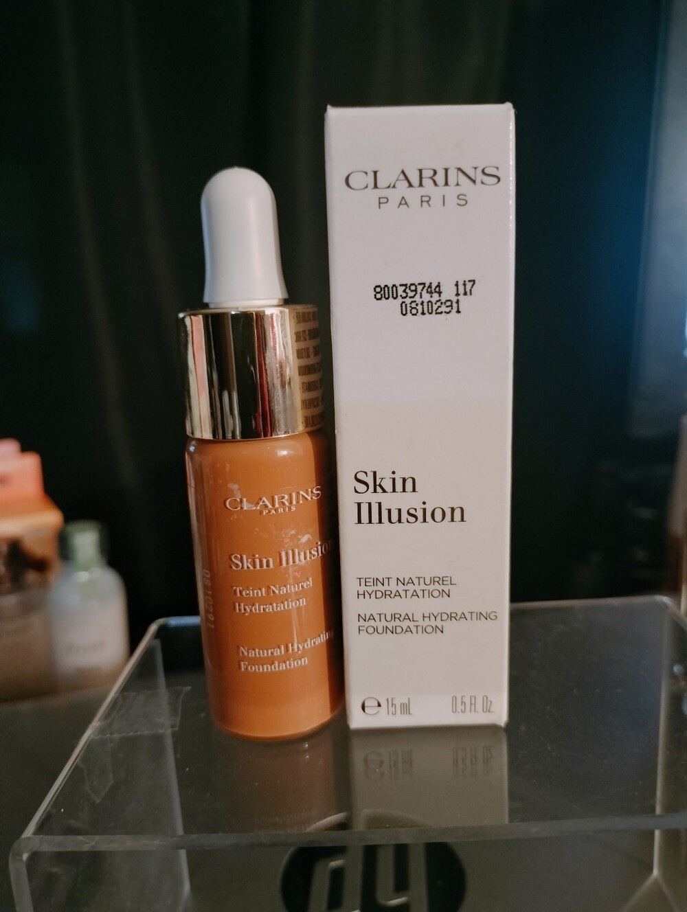 Clarins Skin Illusion Hydrating Foundation Bottle in Warm Tan and White Box
